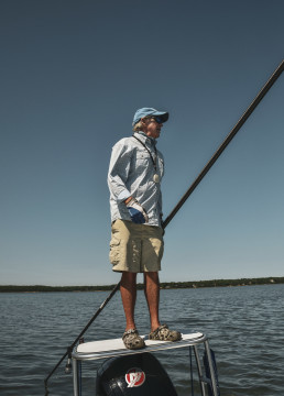 Paul Dixon stands on top of a fishing skiff.