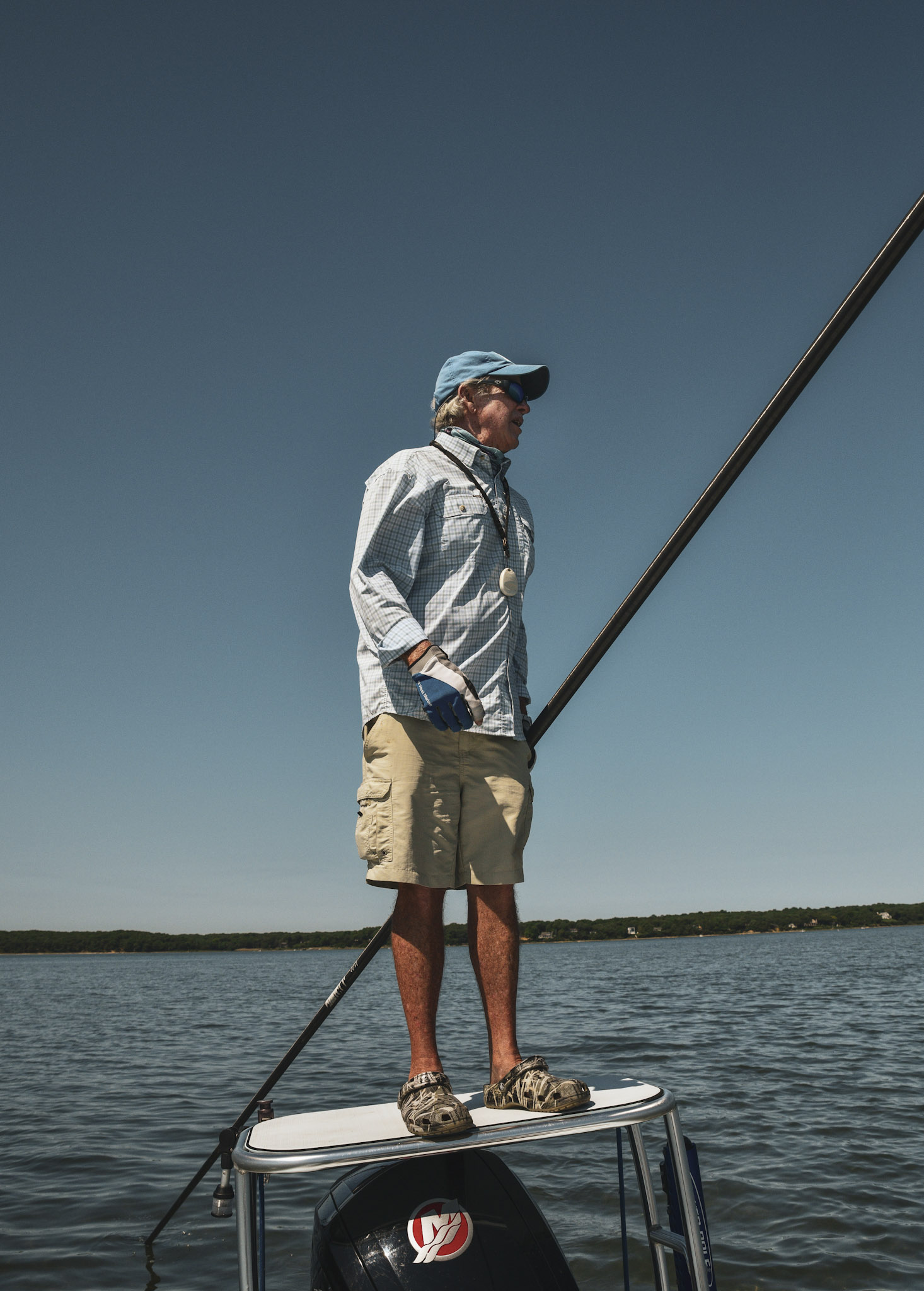 Paul Dixon stands on top of a fishing skiff.