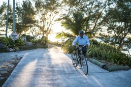 Ansil Saunders pushes his bicycle along a road.