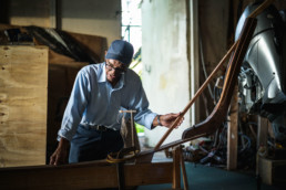 Ansil Saunders tends to a boat in his workshop.