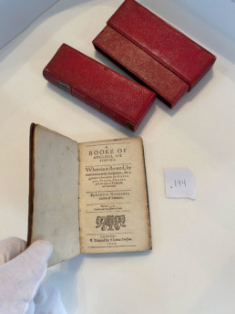 A Booke of Angling, or Fishing. Wherein is showed, by conference with scriptures, the agreement between the fishermen, fishes, fishing of both natures, temporal and spiritual. By Samuel Gardiner, Doctor of Divinity. Mathew 4.19 “I will make you fishers of men.” London. Printed by Thomas Purfoot. 1606. Alongside the book is its red leather case.