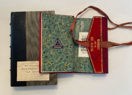 The cover of William Blacker's Art of Fly Making and a red leather fly wallet with 