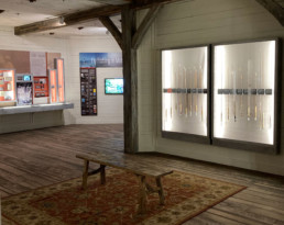 A bench sits in front of two rod panels at at the AMFF gallery at the Wonders of Wildlife.