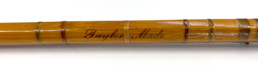 A portion of Joan Wulff's custom bamboo rod with the words Taylor Made painted on it.