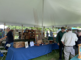 Rods stretch up toward the ceiling of the tent on Carmine Lisella's table.