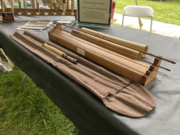 A bamboo rod and rod bag displayed on a table.
