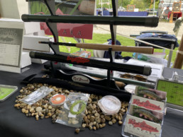 Red Brook Tenkara's display at the festival. The centerpiece is a rod rack holding both rod cases and rod sections.