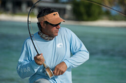 Jose Wejebe grips a rod that's bent nearly in two with the weight of the fish on the line.