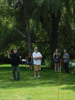 Onlookers watch a participant in the casting competition.