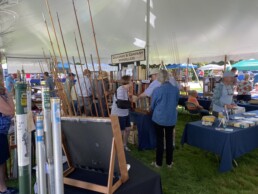 A rack of rods sits in the foreground as patrons examine the books on display at Callahan & Company Booksellers.