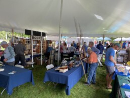 Vendors and visitors in the main tent.