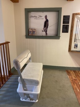 A boat seat sits in front of the Jose Wejebe exhibition.